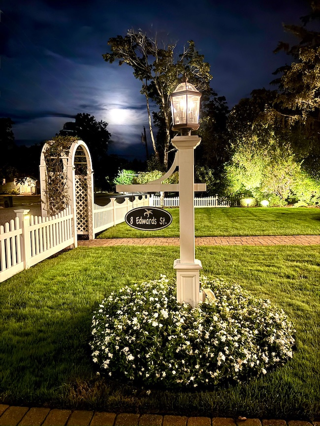 Front Yard on a cool September evening with a full moon behind clouds